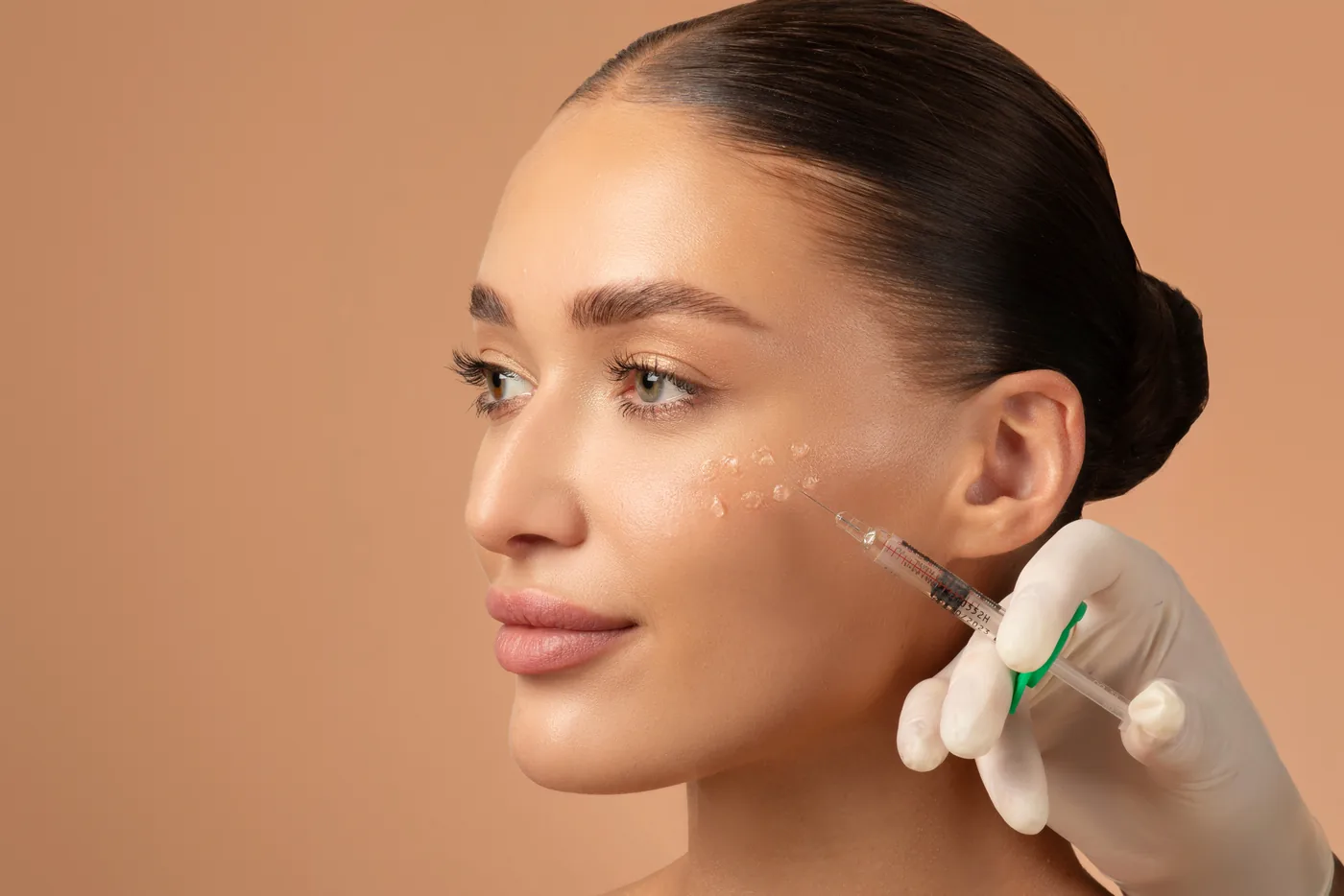 Superficial micro-injections on the cheek during mesotherapy
