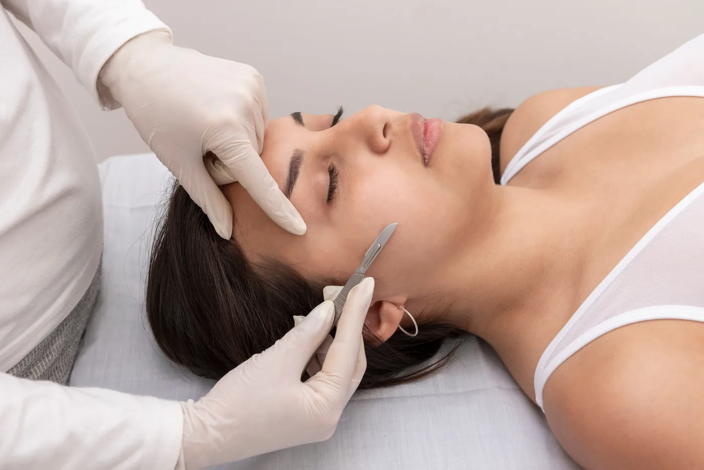 Gentle manual exfoliation treatment along the jawline